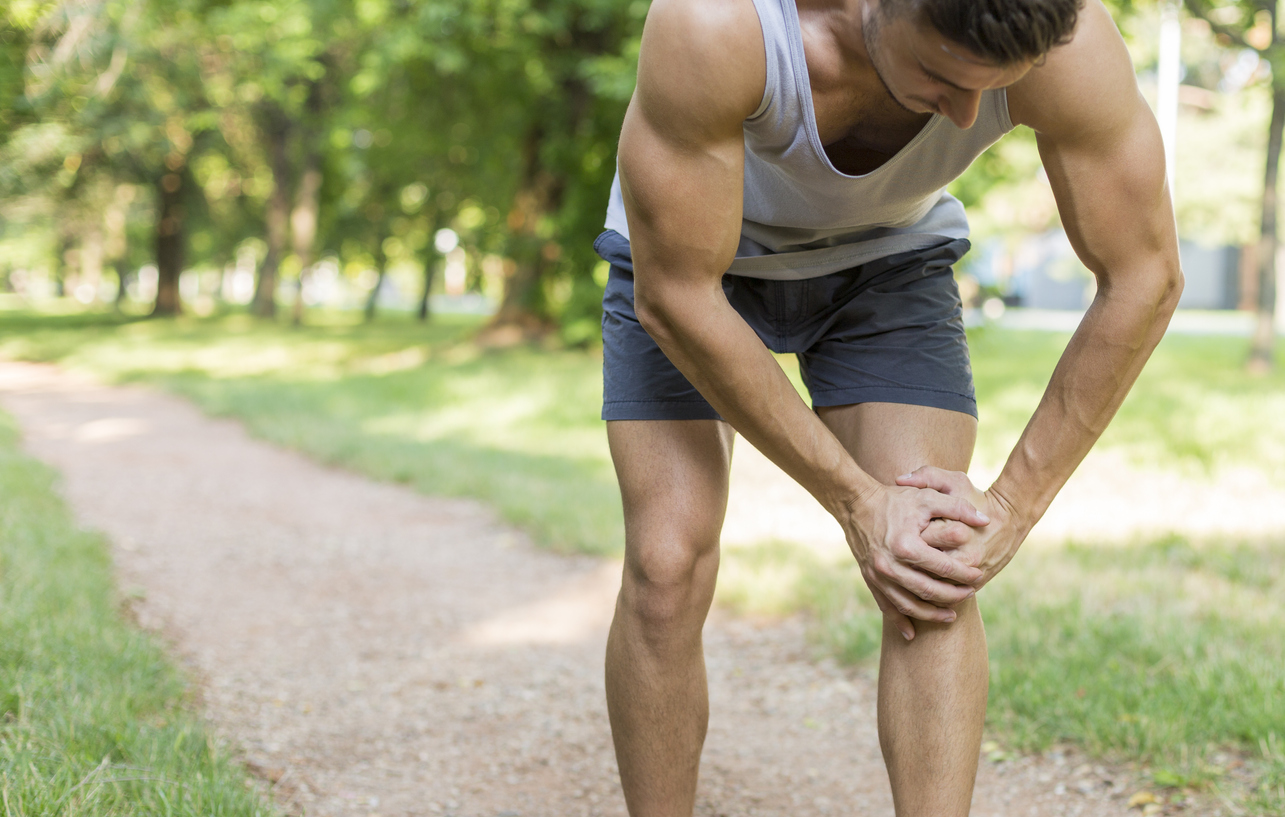 Male runner suffering with pain on sports running knee injury. Sport person often have injury.